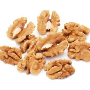 Heap of fresh shelled walnuts on white background. Close-up.